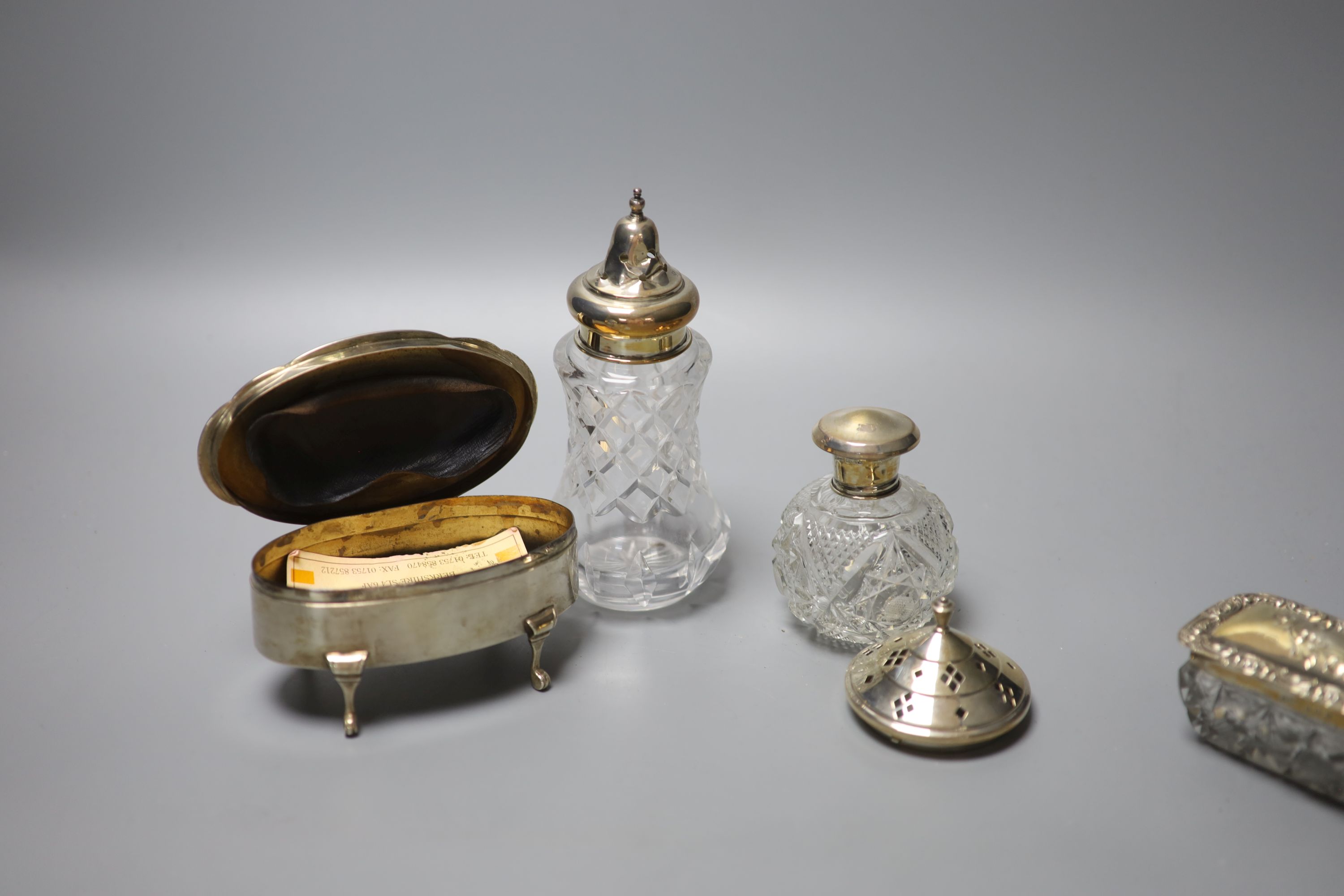A George V silver oval trinket box, 12.5cm, a silver toilet canister and other toilet jars etc.